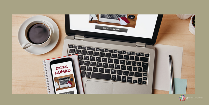 webpage digital nomad laptop with a cup of coffee and a mobile phone with the text "Digital Nomad" on screen.